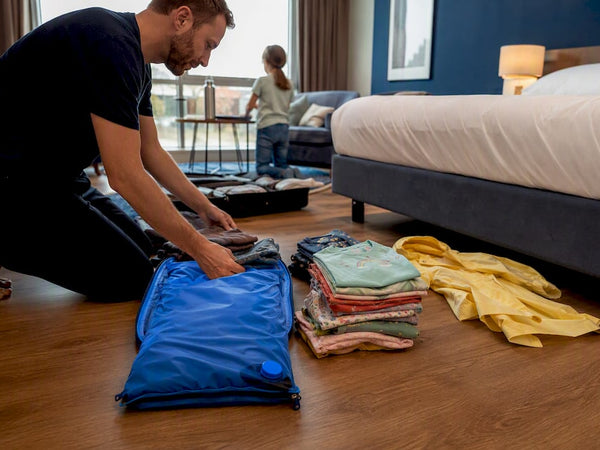 Family travel gear and packing bag on floor