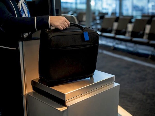 Carry-on bag being weighed at airport gate