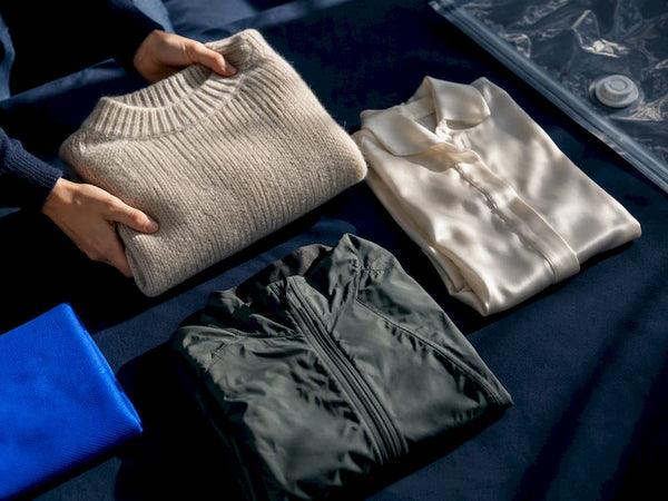 Travel fabrics beside partially visible vacuum bag