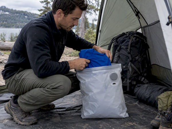 Camper packing a dry sleep set