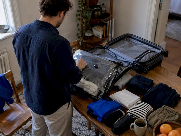 Traveler packing a week into one carry-on